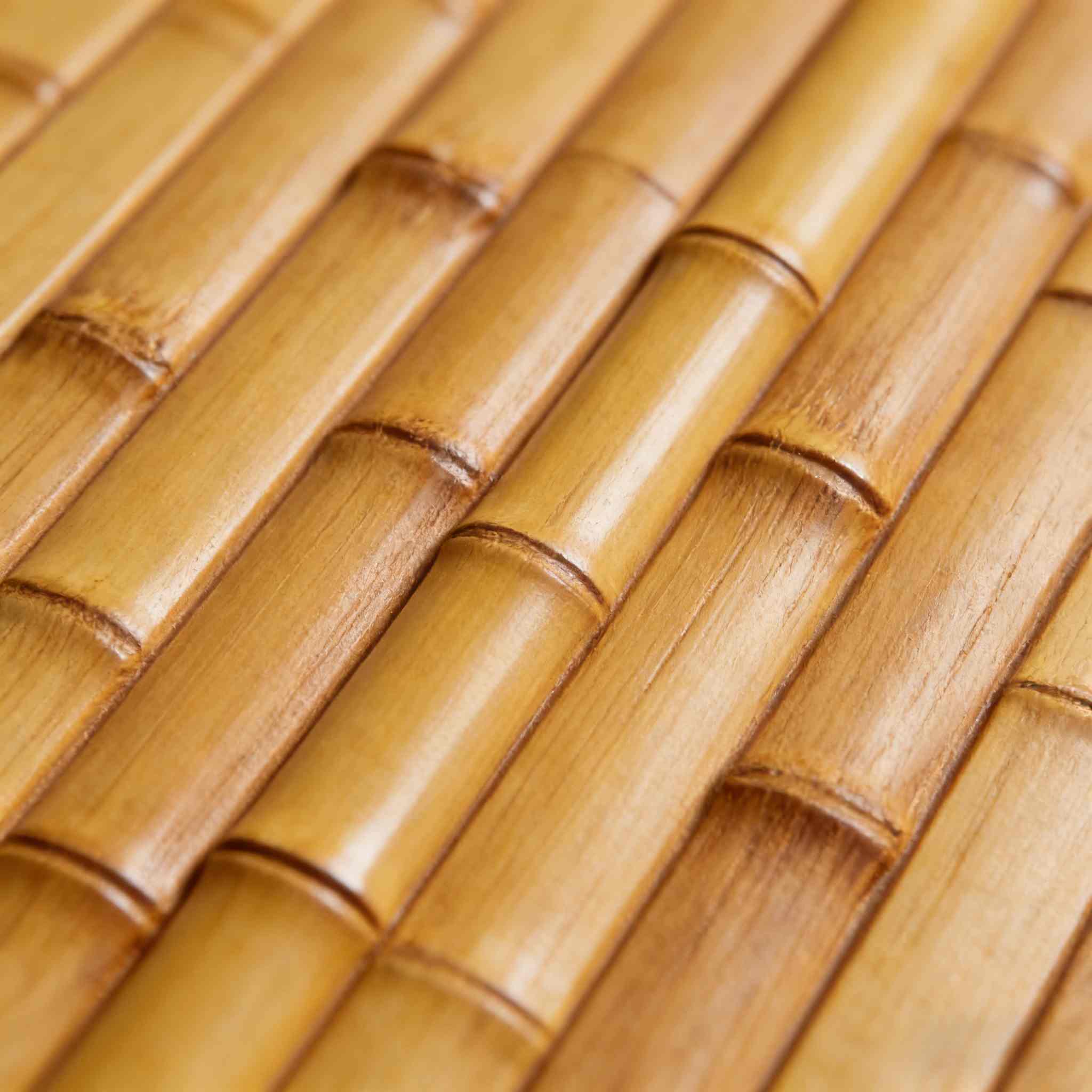 A high-resolution close-up showcasing the fine longitudinal grain, matte or wood-like finish, and uniform material detail of a synthetic bamboo panel.