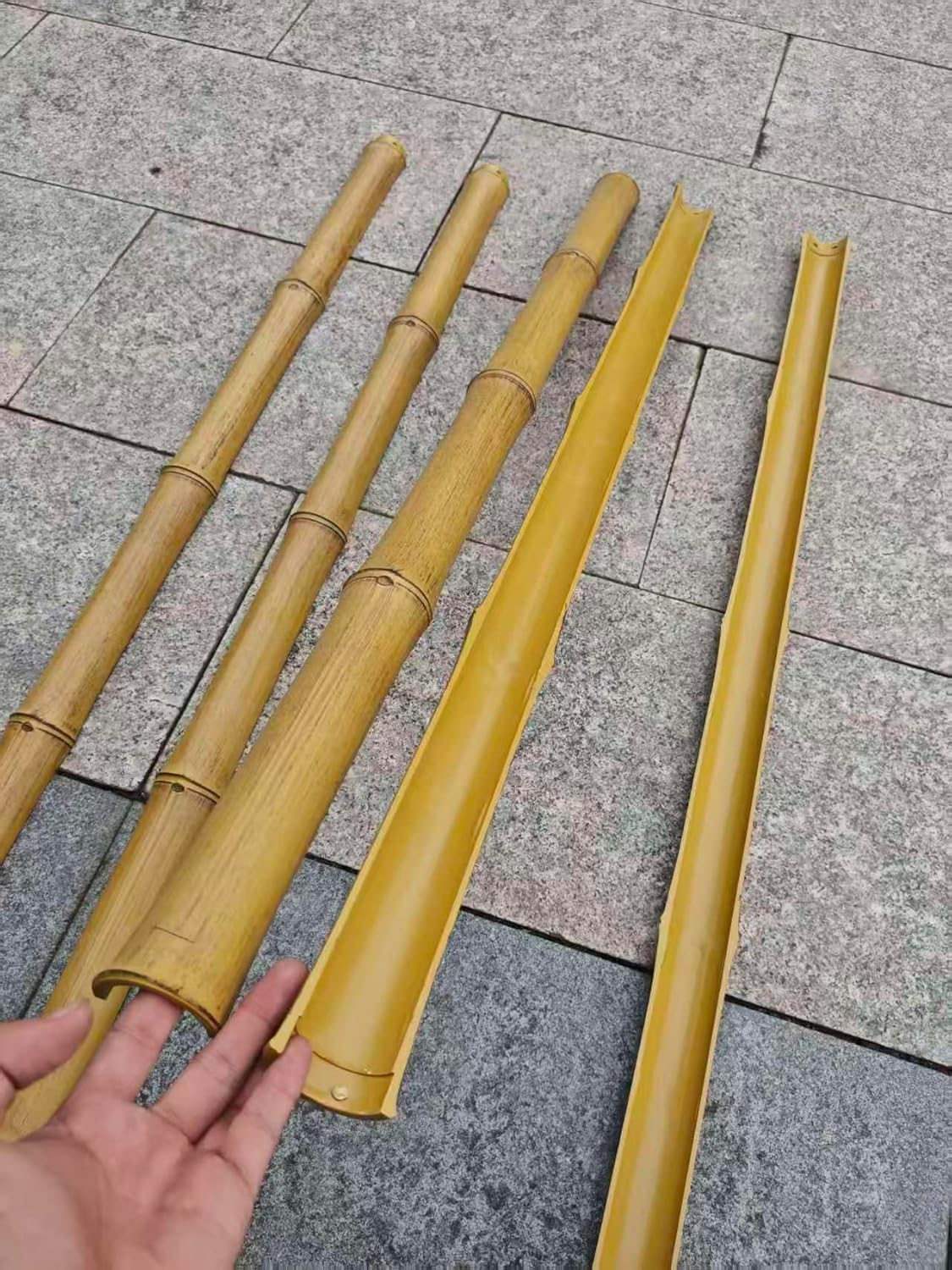 Faux half round bamboo trim showing realistic exterior surfaces and smooth hollow profiles for decorative installation.
