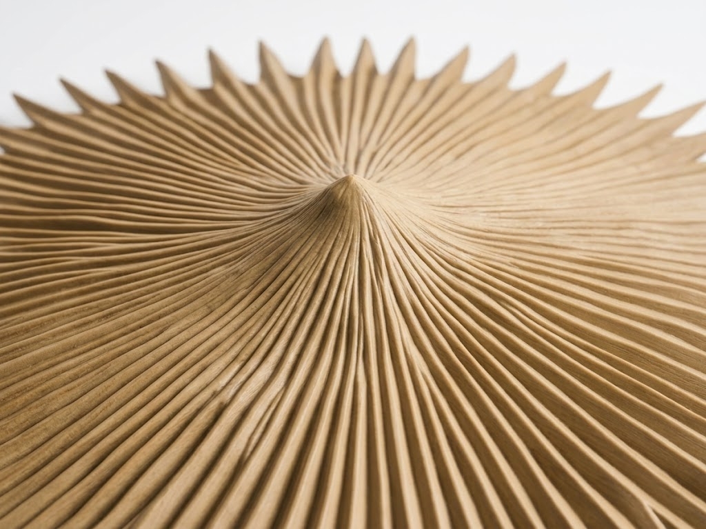 Durable synthetic thatch roof finial showing the central peaked cone